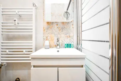 a bathroom with a white sink and a shower at Orchidea City Centre 1BDR by Flat Mаnager in Sofia