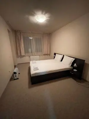 a bedroom with a large bed with white sheets and pillows at Bansko Royal Towers in Bansko