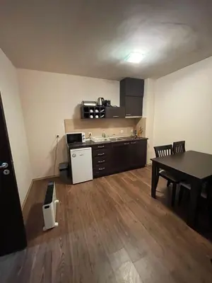a kitchen and dining room with a table and a table and chairs at Bansko Royal Towers in Bansko