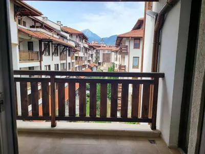 a balcony with a view of buildings and mountains at Bansko Royal Towers in Bansko