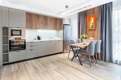 a kitchen and dining room with a table and chairs at Апартхотел Сенатор Пловдив Self check-in in Plovdiv