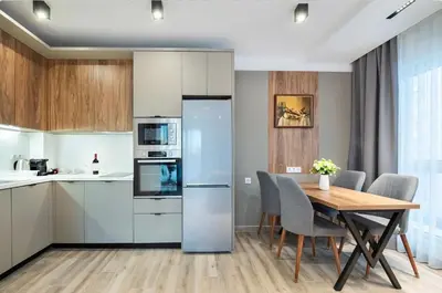 a kitchen and dining room with a table and chairs at Апартхотел Сенатор Пловдив Self check-in in Plovdiv