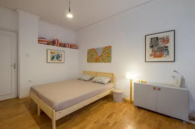 a bedroom with a bed and a dresser in it at THE GOOD PLACE - historical center, unique in Sofia