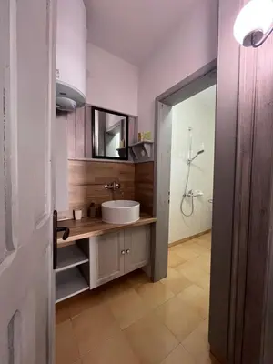 a bathroom with a sink and a mirror at Apаrtment Melnik home in Melnik