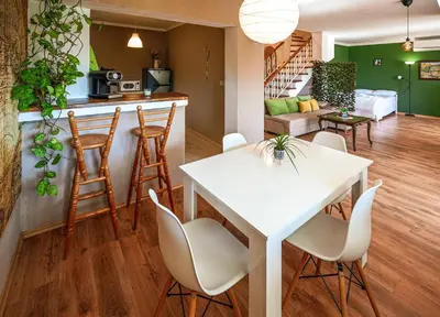 a kitchen and living room with a white table and chairs at 2BDR Yavorov apartment in Sofia