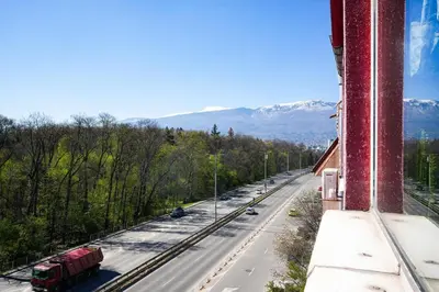 a view of a street with a truck on the road at 2BDR Yavorov apartment in Sofia