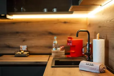 a kitchen counter with a sink and a roll of paper towels at Уютно студио Verde Suites 14 in Blagoevgrad