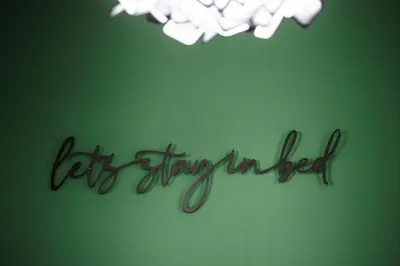 a sign that says let everything improved on a green wall at Уютно Студио Verde Suites 33 in Blagoevgrad