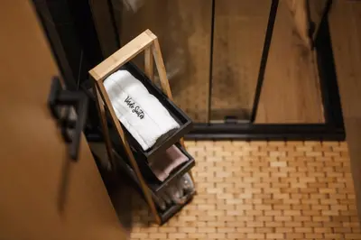a bathroom with a shower with a towel in a box at Уютно Студио Verde Suites 33 in Blagoevgrad