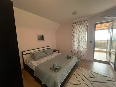 a bedroom with a bed and a large window at BELLA VISTA Holiday Home 24h check in in Sandanski