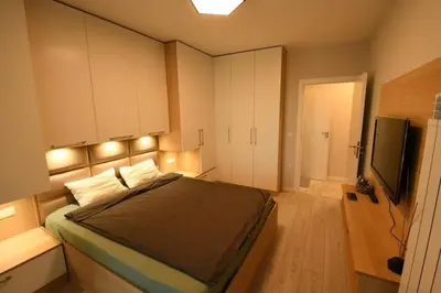 a bedroom with a bed and a flat screen tv at MD Your Fancy Place in Sofia