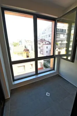 a room with three windows and a view of a city at MD Your Fancy Place in Sofia