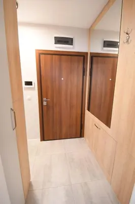 a hallway with a wooden door in a room at MD Your Fancy Place in Sofia