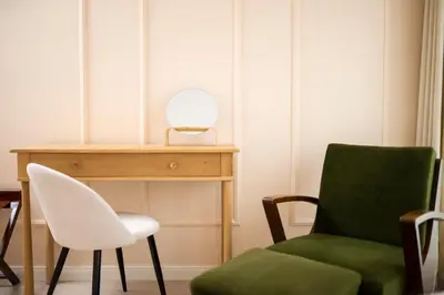 a room with a chair and a desk with a mirror at 21 Villa Vitosha Hills View in Hisarya
