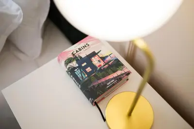 a book sitting on a table next to a lamp at 21 Villa Vitosha Hills View in Hisarya