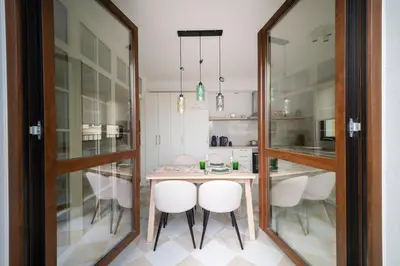 a kitchen and dining room with a table and chairs at 21 Villa Vitosha Hills View in Hisarya