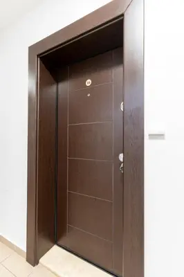 a wooden closet with a glass door at Smart Studio in the heart of Sofia in Sofia