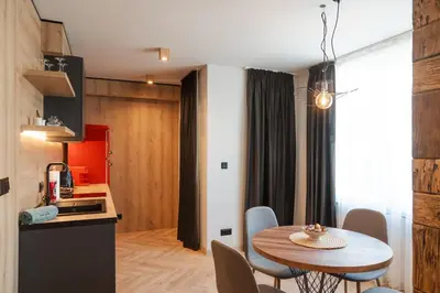 a kitchen and dining room with a table and chairs at Уютно Студио Verde Suites 07 in Blagoevgrad