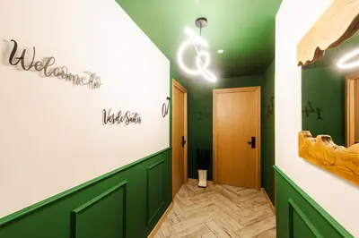 a dressing room with green walls and a hallway at Уютно Студио Verde Suites 07 in Blagoevgrad