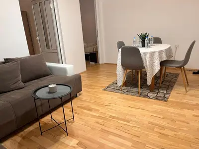 a living room with a couch and a table at Slavveykovs Apartment in Sofia
