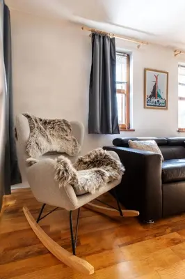 a living room with a chair and a couch at 'Chamonix' in Bansko - 1 bedroom - SKI IN&OUT - Free spa in Bansko
