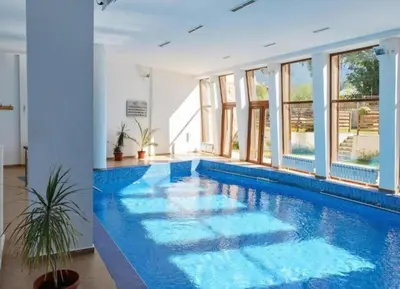 a swimming pool with blue water in a building at 'Chamonix' in Bansko - 1 bedroom - SKI IN&OUT - Free spa in Bansko