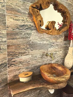 a bathroom with a wooden toilet and a mirror at Къща Томови in Devin