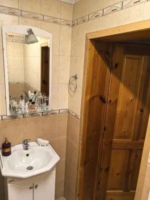 a bathroom with a sink and a mirror at Къща Томови in Devin