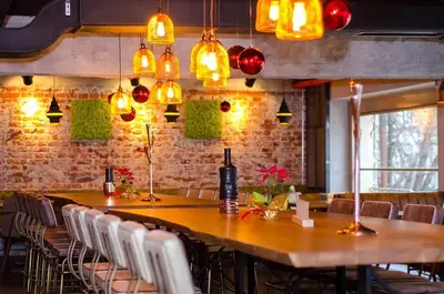 a dining room with a table and chairs and lights at Central Springs Apartment in Sofia