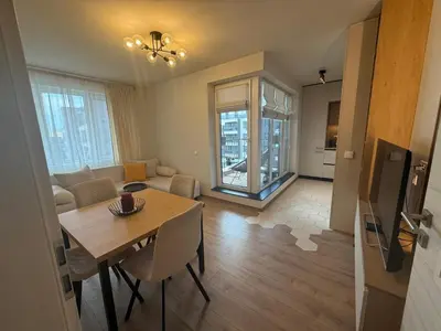 a living room with a table and a dining room at Koko's Cozy Apartment - free Garage Netflix and Balcony in Sofia