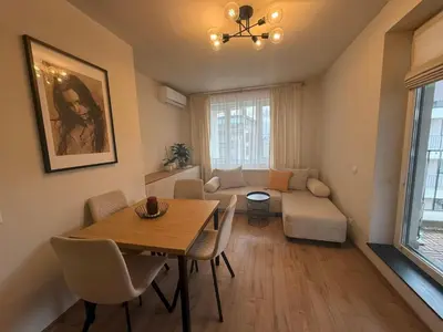 a living room with a table and a couch at Koko's Cozy Apartment - free Garage Netflix and Balcony in Sofia