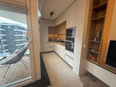 a kitchen with a door open to a balcony at Koko's Cozy Apartment - free Garage Netflix and Balcony in Sofia