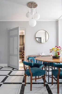 a dining room with a table and chairs and a mirror at Landmark Luxe 2BR Apt with Parking in Sofia