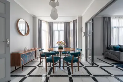 a living room with a table and chairs and a couch at Landmark Luxe 2BR Apt with Parking in Sofia