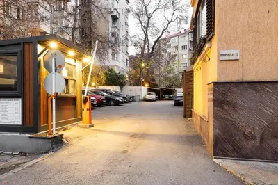 a street with a yellow building and a parking meter at Casa Dolce far niente , in Blue, PARKING in Sofia