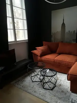 a living room with a couch and a table at Urban Comfort - Central 1BDR near Vitoshka & NDK by Flat Mаnager in Sofia