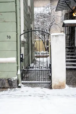 a wrought iron gate in front of a building with snow at Vitoshka Inn in Sofia