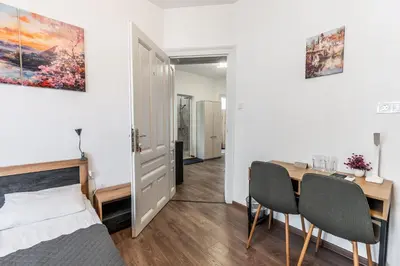 a bedroom with a bed and a desk and a table at Vitoshka Inn in Sofia