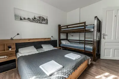 a bedroom with a bed and a bunk bed at Vitoshka Inn in Sofia