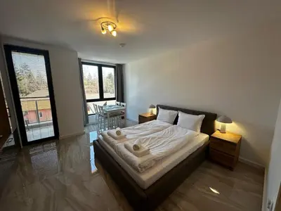 a bedroom with a bed with two towels on it at Apartment Aria 4 in Velingrad