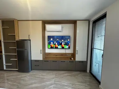 a kitchen with a flat screen tv on the wall at Apartment Aria 4 in Velingrad