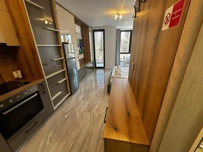 a kitchen with a wooden bench in a room at Apartment Aria 4 in Velingrad