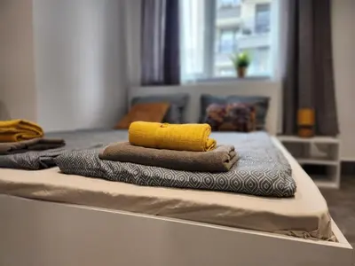 a pile of towels sitting on top of a bed at Continental studios 1 in Sofia