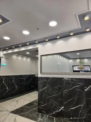 a meeting room with a projection screen and marble floors at Continental studios 5 in Sofia