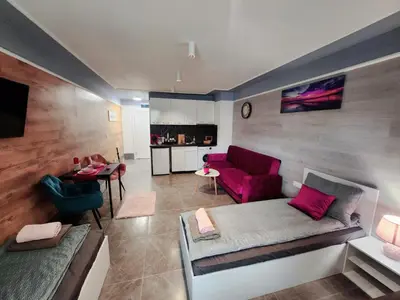 a living room with a couch and a table at Continental studios 3 in Sofia