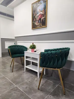two green chairs and a table in a room at Continental studios 2 in Sofia