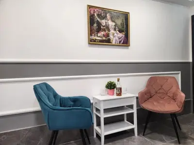 two chairs and a table with a bottle of wine at Continental studios 2 in Sofia