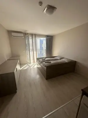 a bedroom with a bed and a large window at Good Morning in Sofia