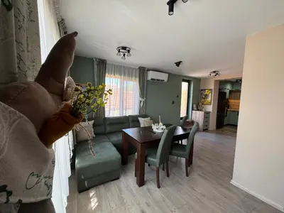 a living room with a couch and a table at Kamberovi house Kalofer Къща Камберови Калофер in Kalofer