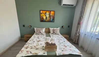 a bedroom with a bed with a box on it at Kamberovi house Kalofer Къща Камберови Калофер in Kalofer